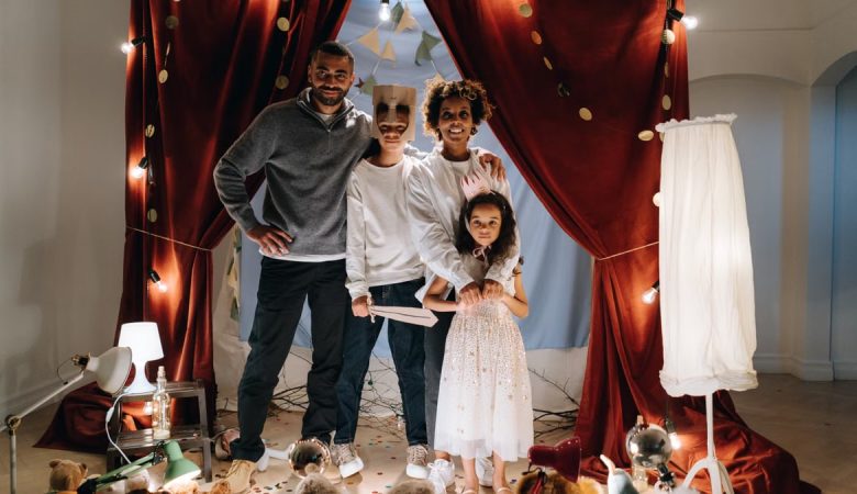 A joyful family enjoying imaginative play in a home theatre setting with costumes and creativity.